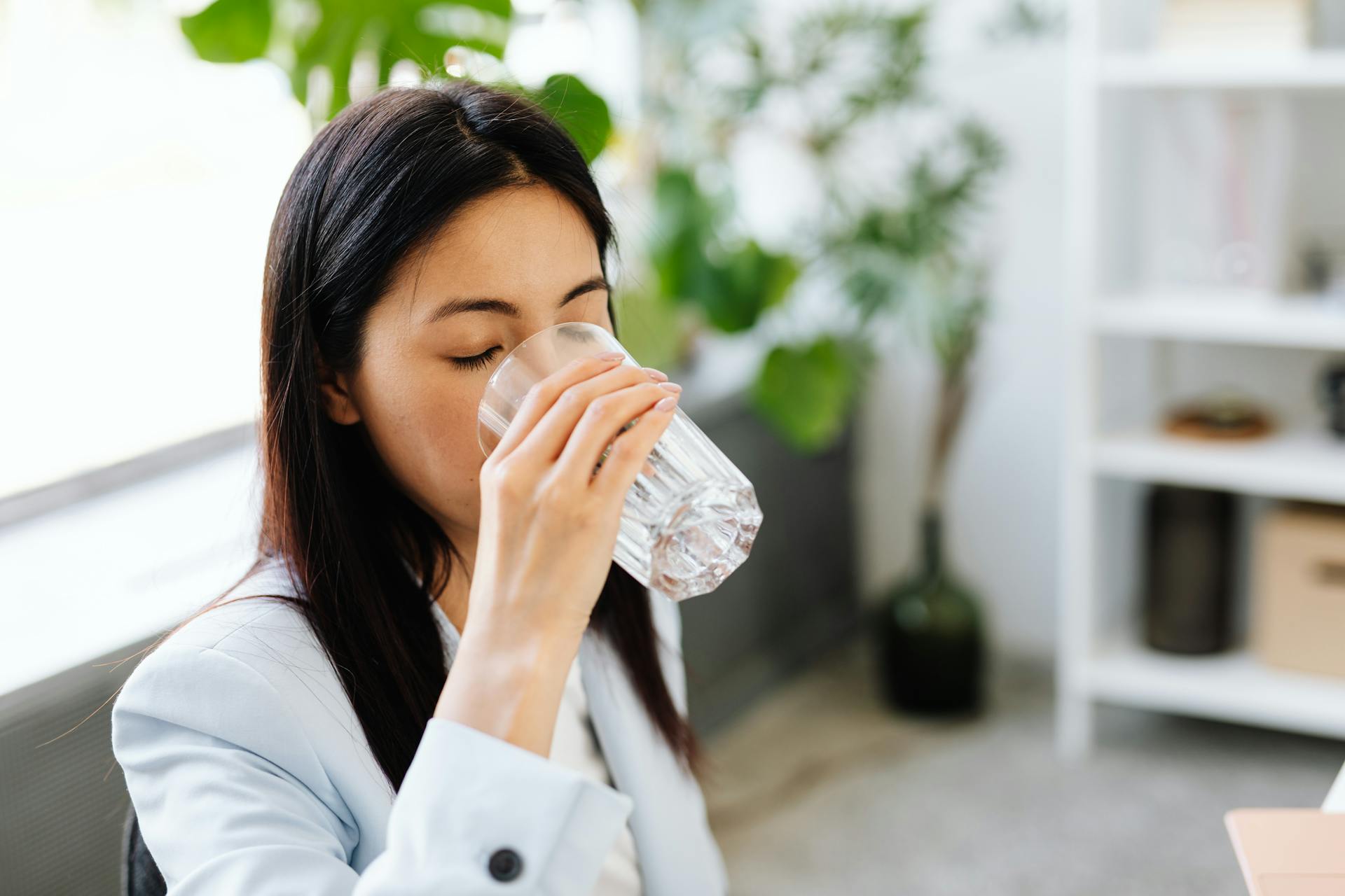 woman drinking water in her morning routine