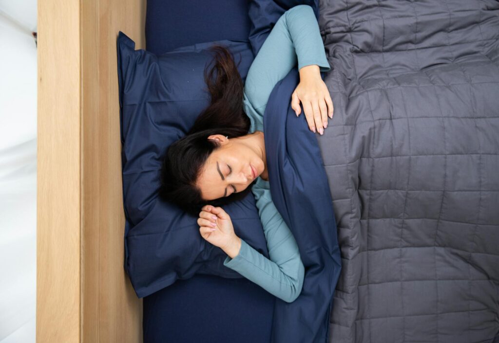 a woman sleeping in a bed