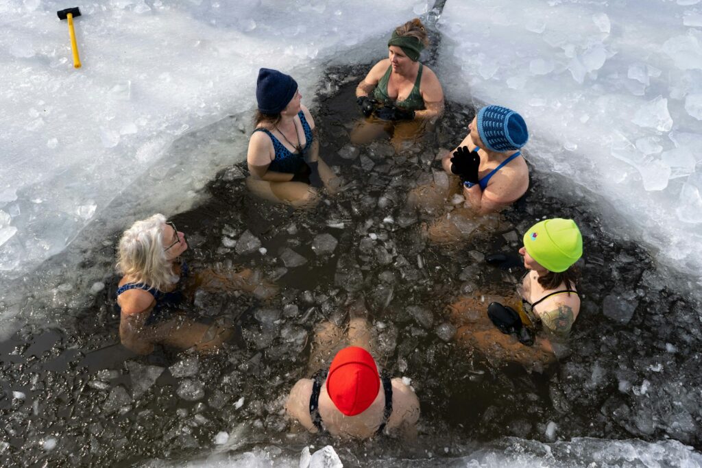 A group of people sitting around a pool of water